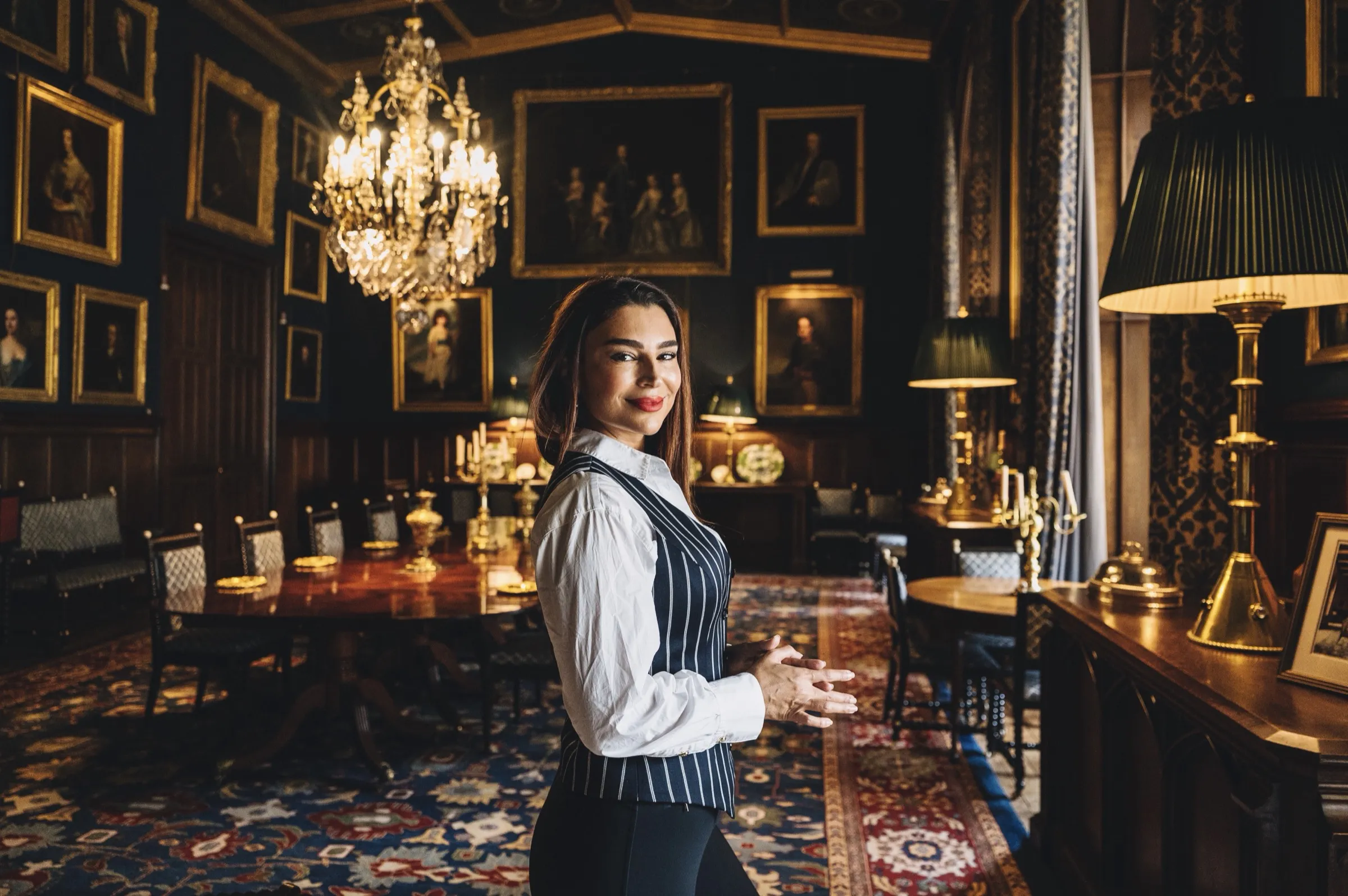 Handan Darici in a candlelit, wood-panelled dining hall